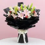 A vibrant bouquet featuring pink and white lilies arranged elegantly.