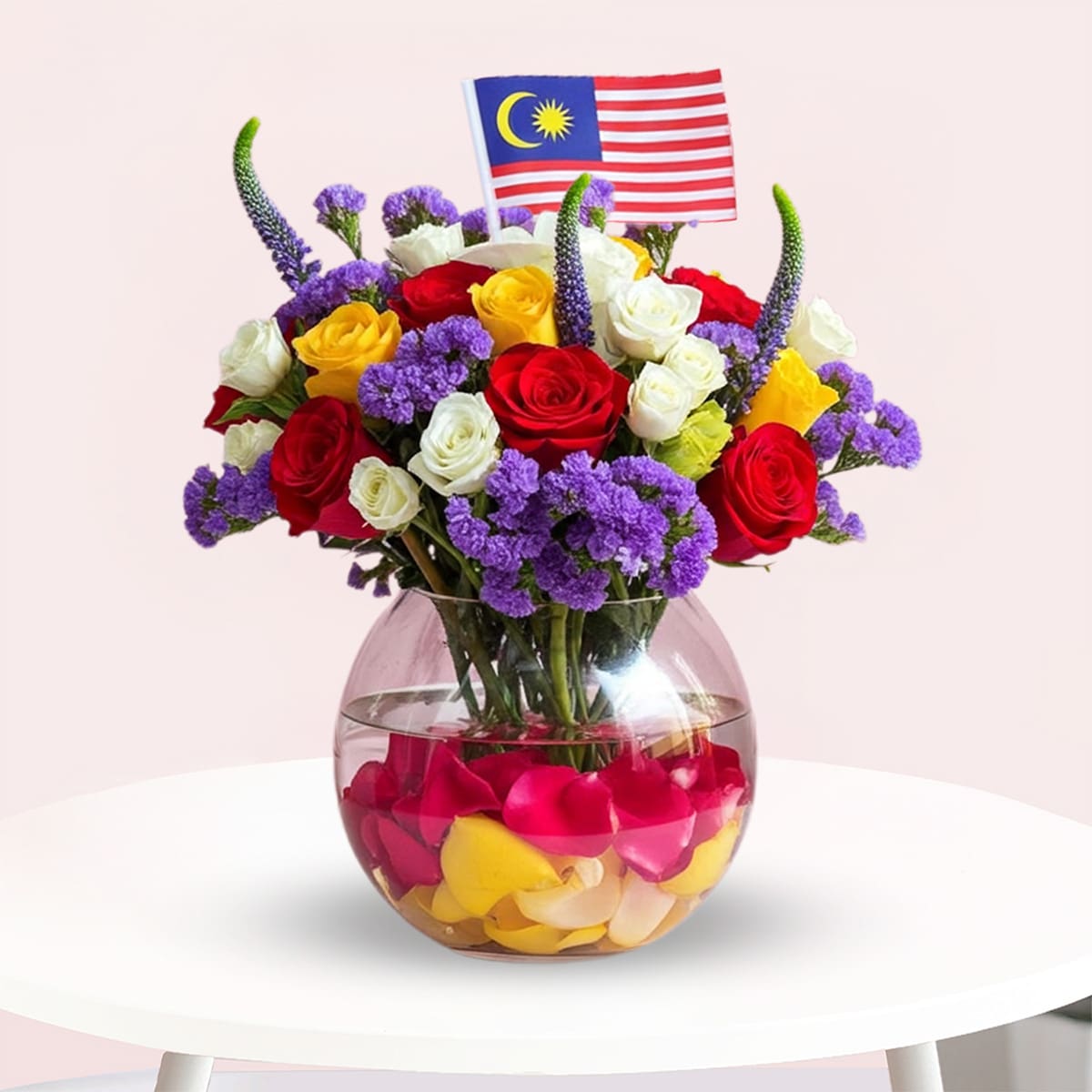 Unity Bloom Bowl-01-26 AGlass vase with red, white and yellow roses, purple statice and a Malaysian flag.