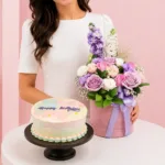Chocolate Chiffon & Flowers Combo featuring a bouquet of lavender and pink roses, eustoma, matthiola, and fillers paired with a Black Forest cake made with chocolate chiffon, fresh cream, and dark sweet cherries.