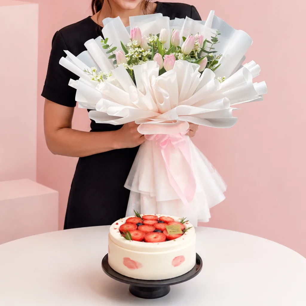 Pink Flowers & Chiffon Cake Combo featuring a hand bouquet of 10 pink tulips with greenery paired with a vanilla chiffon cake filled with lychee mousse and lychee fruit.