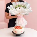 Pink Flowers & Chiffon Cake Combo featuring a hand bouquet of 10 pink tulips with greenery paired with a vanilla chiffon cake filled with lychee mousse and lychee fruit.