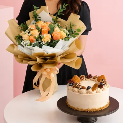 Romantic Flowers Walnut Cake Combo featuring a hand bouquet of peach roses and greenery paired with a rich Coffee Walnut cake made with coffee chiffon, peanut butter, custard cream, and walnuts.