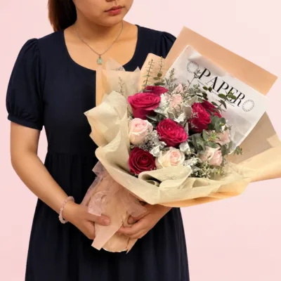 Royal Romance Bouquet featuring dark pink and light pink roses arranged with dusty miller, eucalyptus, and decorative fillers in an elegant romantic floral design.