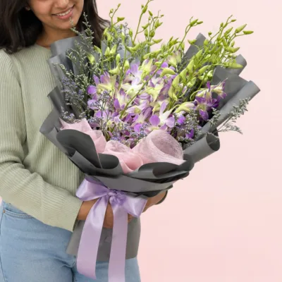 Pink Dendrobium orchid bouquet with fresh greeneries and elegant gift wrapping